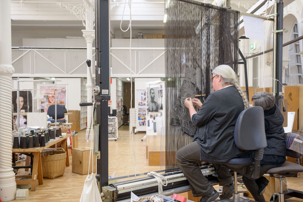 Chris Cochius weaving on the veil of 'Catching Breath', 2015, Brook Andrew. Photo: Jeremy Weihrauch. 