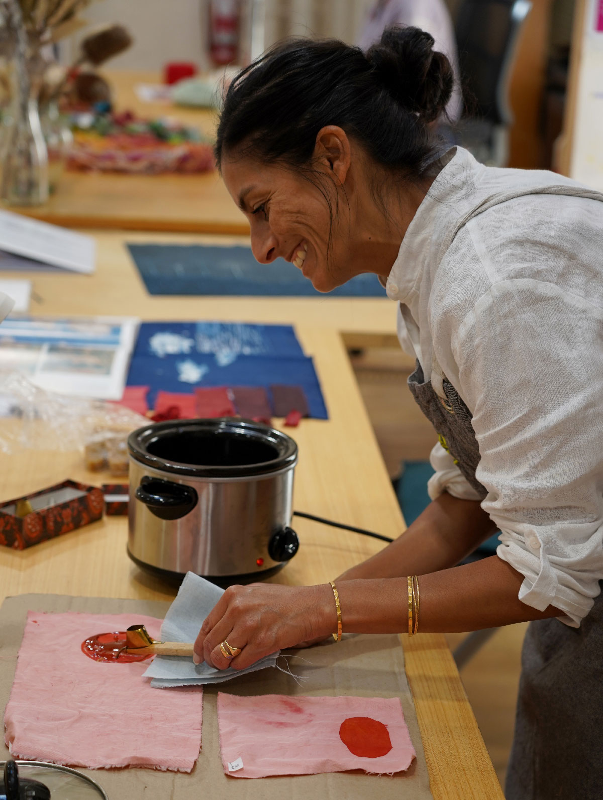 Sangeeta Sandrasegar in her residency studio applying wax to fabric