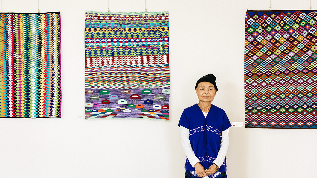 Artist Mu Naw Poe with Full Circle: Karen Tapestry Weavers Exhibition In Situ. Photo by Marie-Luise Skibbe