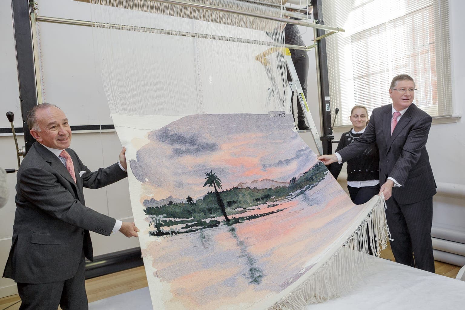 Cutting Off Ceremony for ‘Rufiji River from Mbuyuni Camp, Selous Game Reserve, in Tanzania,’ 2014, designed by HRH Prince of Wales, woven by Chris Cochius and Pamela Joyce, wool and cotton, 1.37 x 1.73m. Photograph: Jeremy Weihrauch.