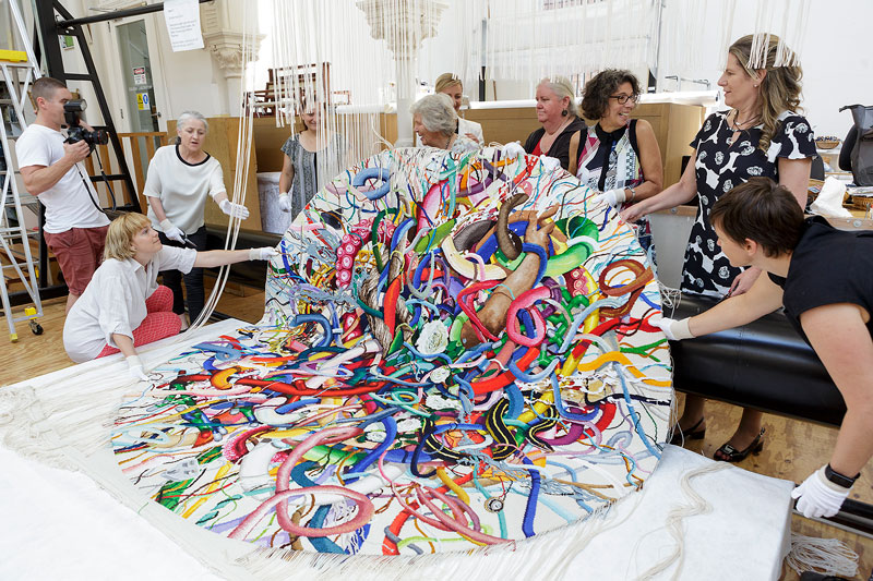 Cutting Off Ceremony for 'Gordian Knot' 2016, designed by Keith Tyson and woven by Chris Cochius, Sue Batten, Pamela Joyce & Milena Paplinska, wool and cotton, 2.4 x 2.4m. Photograph: Jeremy Weihrauch.