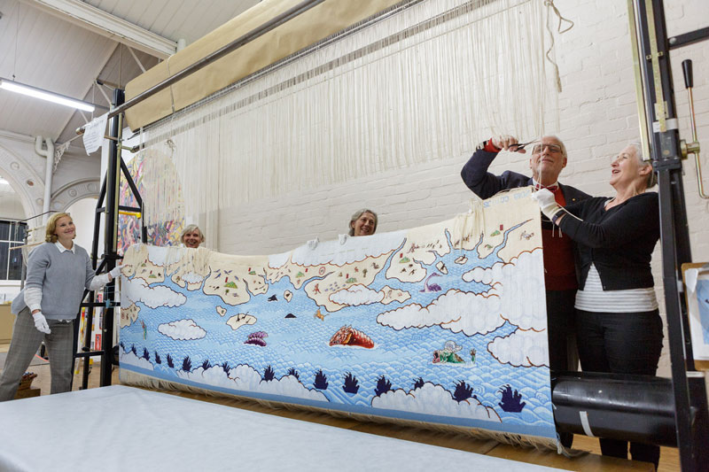 Cutting Off Ceremony for 'Treasure Hunt' 2018, designed by Guan Wei and woven by Chris Cochius, Pamela Joyce, Jennifer Sharpe & Cheryl Thornton being cut from the loom. Photograph: Jeremy Weihrauch .