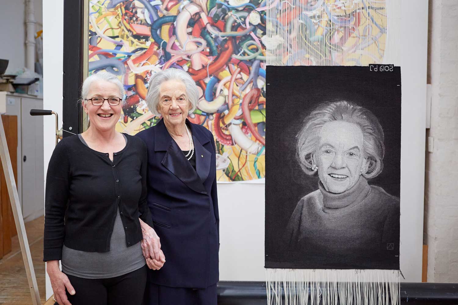 The Honourable Margaret Lusink AM with ATW weaver Pamela Joyce in front of the finished tapestry, 2019. Photograph Jeremy Weihrauch. 