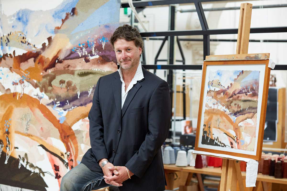 Artist Luke Sciberras in front of the completed ‘Bridle Track, Hill End’ tapestry, designed in 2019 and woven by Chris Cochius, Sue Batten, Amy Cornall, Karlie Hawking & Pamela Joyce, wool, cotton, 1.6 x 1.6m. Photo by Jeremy Weihrauch. 