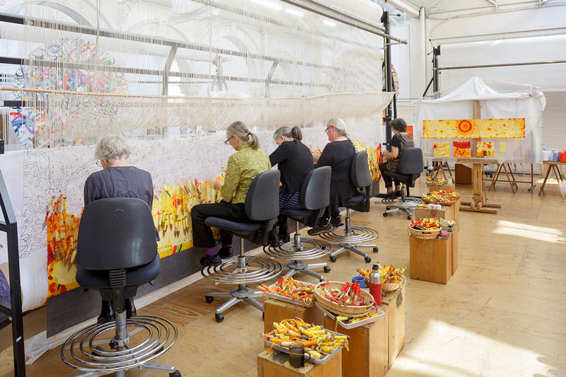 ATW weavers working on 'Life Burst' designed by John Olsen AO OBE in 2016 and woven by Pamela Joyce, Sue Batten, Chris Cochius, Jennifer Sharpe and Cheryl Thornton. Photograph: Jeremy Weihrauch.
