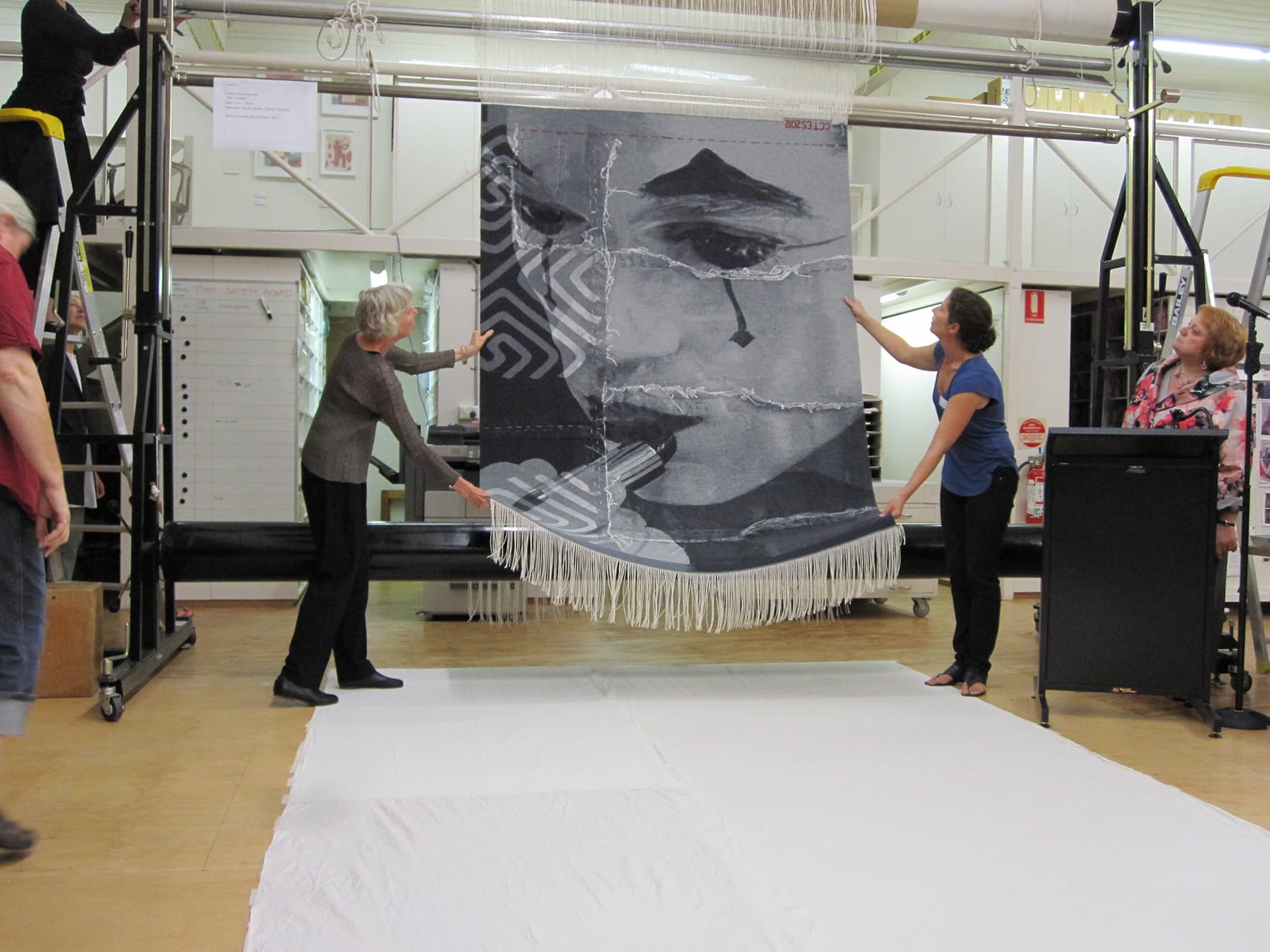 Cutting Off Ceremony for ‘Untitled’ 2012, designed by David Noonan, woven by Emma Sulzer & Cheryl Thornton, wool and cotton, 2.00 x 1.63m. Photograph: ATW.